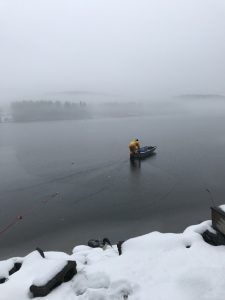 John Cooley heading out in a boat on the ice to rescue Loon