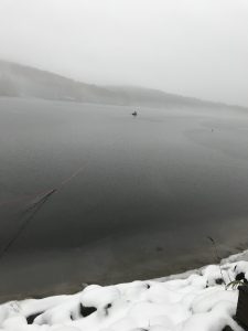 John Cooley heading out in a boat on the ice to rescue Loon